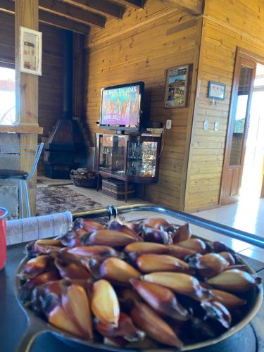 a plate of food on a table in a room at Chalé Guadalupe - Condomínio Altos da Serra in Bom Jardim da Serra