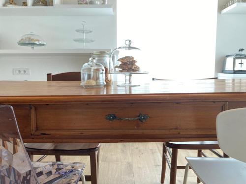a wooden table with a glass jar on top of it at Combo Rooms in Garna dʼAlpago