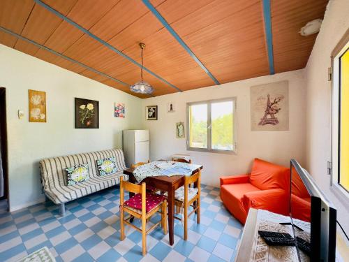 a living room with a table and a couch at Bilocale a due passi dalla piazza di Rena Majore in Rena Majore