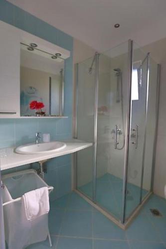 a bathroom with a glass shower and a sink at Villa Andromeda in Sivota