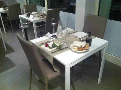 a white table with a plate of food on it at A Lago in Marone