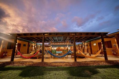 a patio with three hammocks in a house at Bonito Ecotel in Bonito
