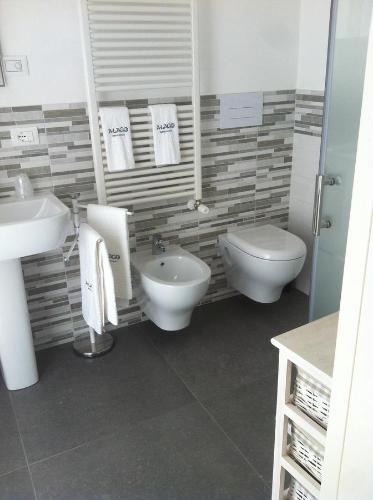 a bathroom with a toilet and a bidet and a sink at A Lago in Marone