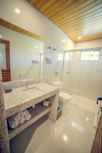 a bathroom with a sink and a toilet and a mirror at Bonito Ecotel in Bonito