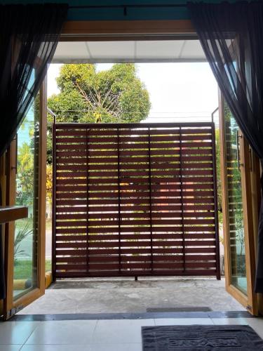 an open door to a room with a large window at Naisang Hostel in Chumphon