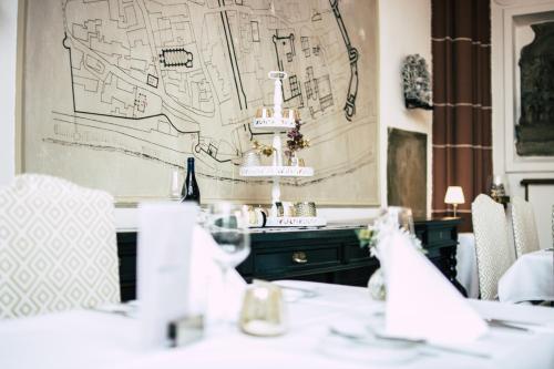 a room with a table with a map on the wall at Boutiquehotel Kloster Pfalzel in Trier