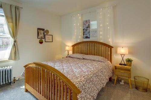 a bedroom with a bed and two lamps and a window at Darling Pennsylvania Vacation Rental with Porch! in Pottstown