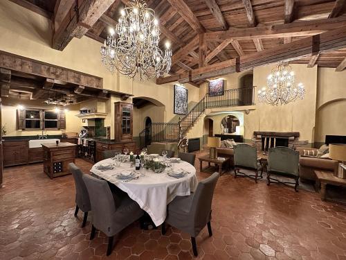 a large dining room with a table and a kitchen at Le Hameau in Figari