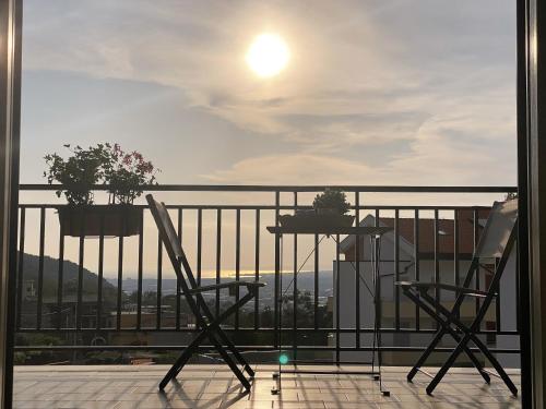 a balcony with two chairs and a table at Cerchia Apartments in Corbara