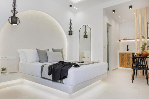 a white bedroom with a bed in a room at Naxos Alegria Luxury Apartment in Naxos Chora