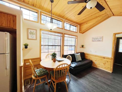 a living room with a table and a couch at Sally's Cabin is a quaint two bedroom tiny home in Woodland Park