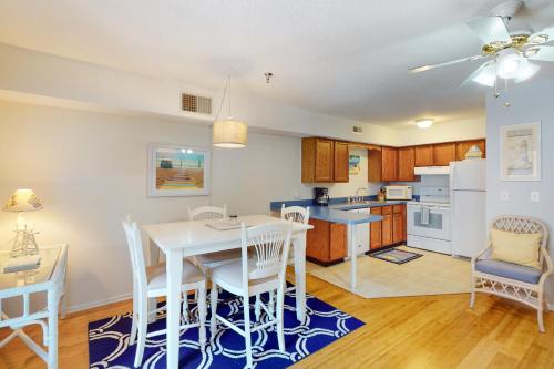 a kitchen and dining room with a table and chairs at Sandalwoods 101A in Ocean City