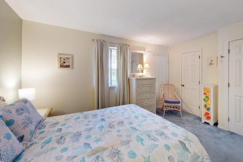 a bedroom with a bed and a dresser at Sandalwoods 101A in Ocean City