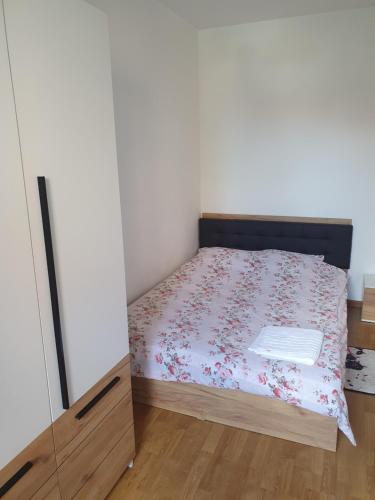 a small bedroom with a bed and a mirror at Sweet in Sibiu
