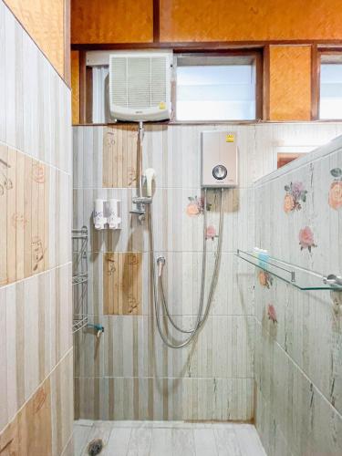 a shower in a bathroom with a glass shower stall at U Maerim Chiangmai - อยู่แม่ริม เชียงใหม่ in Mae Rim