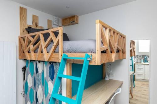 a bunk bed in a small room with a desk at Le Rêve Bleu in Brest