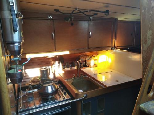 a kitchen with a sink and a stove top oven at Cyclades sailing Experience in Finikas