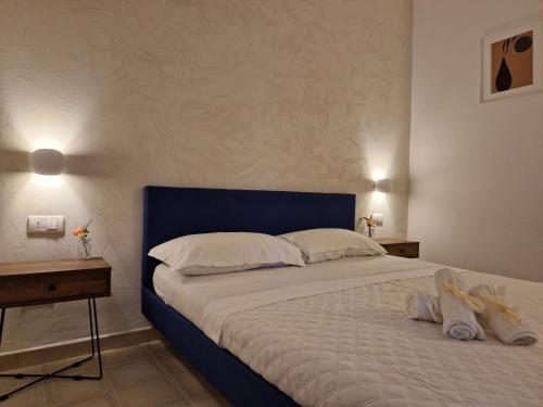 a bedroom with a bed with two stuffed animals on it at Hotel - Giardino Marchese D'Altavilla in Tropea