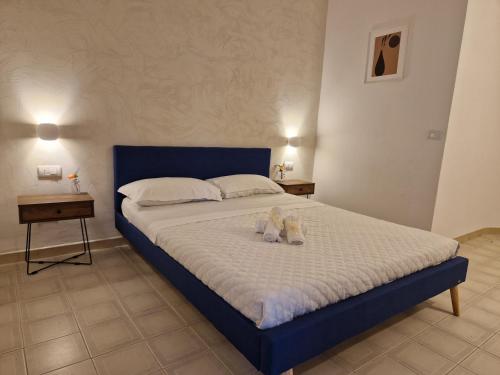 a bedroom with a bed with two stuffed animals on it at Hotel - Giardino Marchese D'Altavilla in Tropea