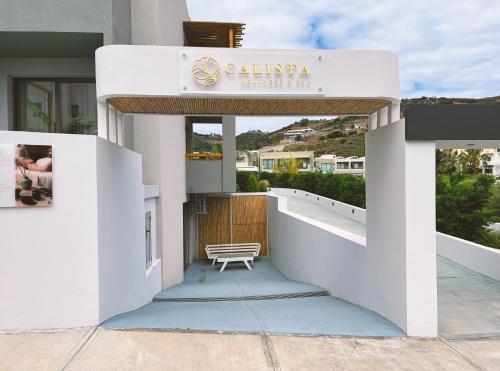 a white building with a sign that reads calistina living room at Bali Star Resort Hotel in Balíon