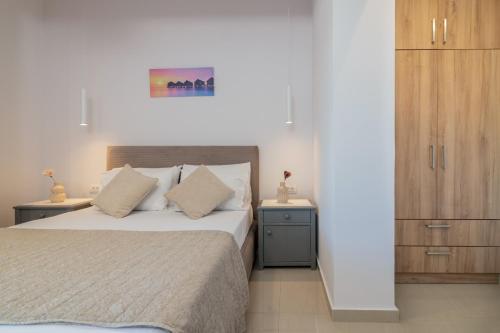 a bedroom with a bed and a wooden cabinet at Villa Jolla-Private Pool-Ideal for big groups By Villa Mana Gers in Kalamaki