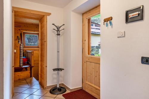 a room with a walk in shower next to a door at Muncion Apparte in Pozza di Fassa