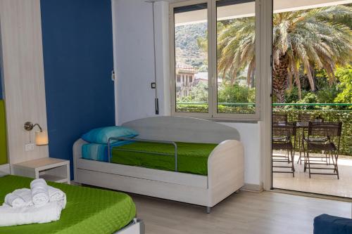 a small bedroom with a bed and a balcony at Exclusive in Palermo