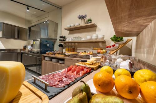 a kitchen with a bunch of fruit on a table at Goloritzè Room and Breakfast in Baunei