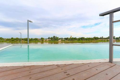 a swimming pool with a view of a river at Departamento Puerto in Santa Fe