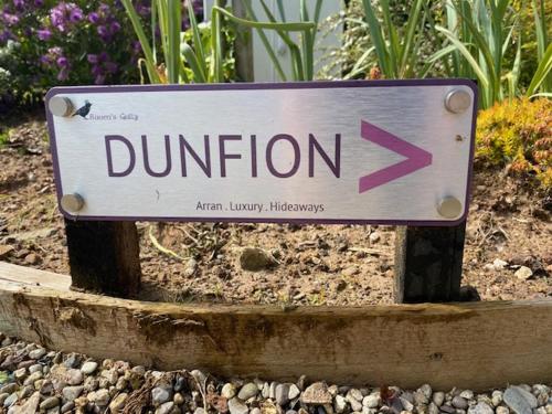 a sign that says dunion with a purple arrow at Raven's Gully - Brodick, Isle Of Arran in Brodick