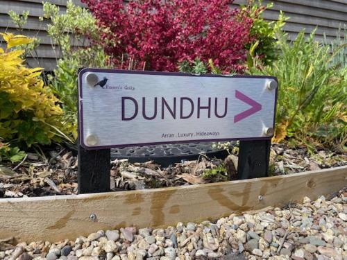 un panneau qui dit dundubb dans un jardin dans l'établissement Raven's Gully - Brodick, Isle Of Arran, à Brodick