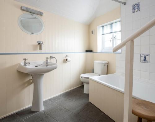 a bathroom with a sink and a tub and a toilet at St Samson in Port Isaac