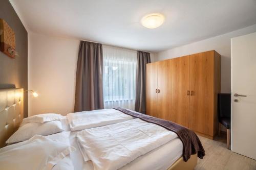 a bedroom with a large white bed and a window at Residence Alpina Comfort Nr 1 in Tesimo