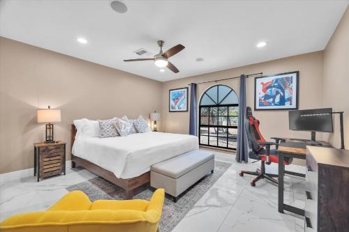 a bedroom with a bed and a desk and a tv at Ranch style villa with pool and spa in Las Vegas