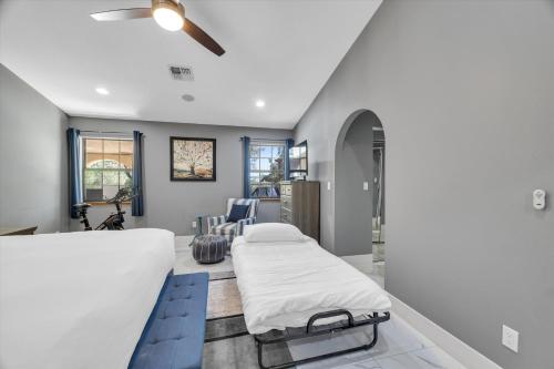 a bed in a room with a ceiling fan at Ranch style villa with pool and spa in Las Vegas