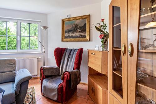 a living room with a chair and a tv at Ferienwohnung Alexandra in Rheinfelden