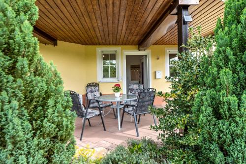 a patio with a table and chairs on it at Ferienwohnung Alexandra in Rheinfelden