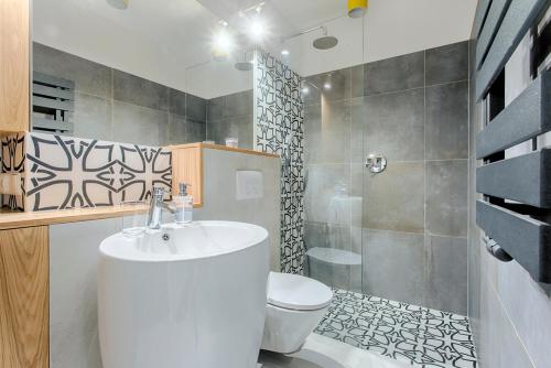 a bathroom with a white sink and a toilet at Tyzenhauz Apartments Arianska Street in Krakow