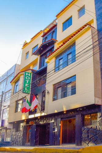 a tall building with a sign in front of it at Casona Plaza Balsa Inn in Puno