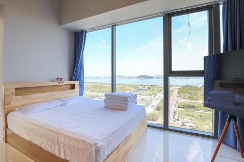 a bedroom with a bed and a large window at Romang House in Incheon