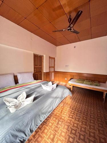 a large bed in a room with a ceiling at Zambala guest house in Deskit
