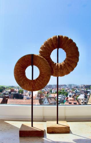 two donuts on display in front of a window at Viviane - Beautifull view, Garage, 200m from beach in De Panne
