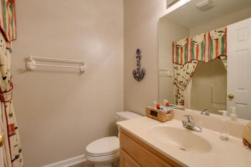a bathroom with a sink and a toilet and a mirror at Lake Hartwell Vacation Rental with Dock and Hot Tub! in Fair Play