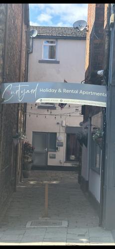 a building with a sign that reads gardenotherapy and renewal apprentice at Courtyard Holiday Apartments in Belper