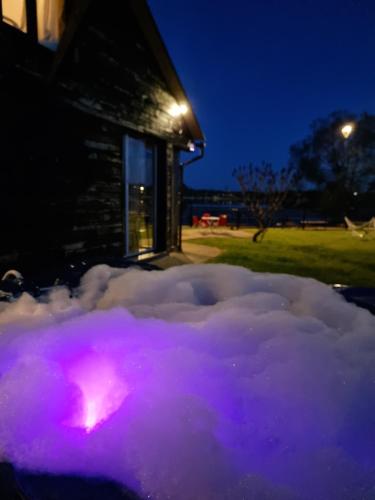 a pile of snow in front of a building at night at Add Story Guest House in Rēzekne