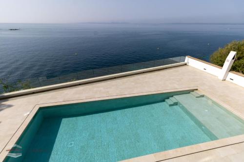a swimming pool with a view of the ocean at Vista Roses Mar - El Brancs in Roses