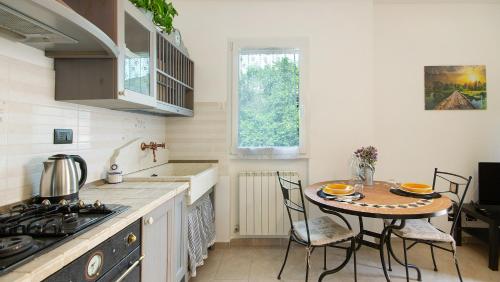 a kitchen with a table and a small table with chairs at Casa Pullin in Carasco