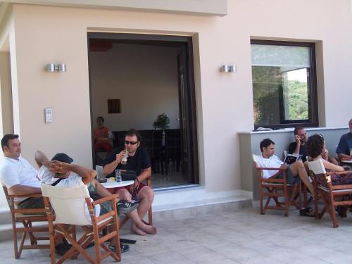 a group of people sitting around a table in chairs at Avaton Hotel in Ligourio