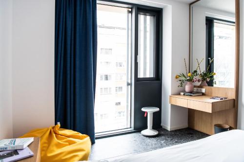 a bedroom with a bed and a large window at Hotel Kitchen59 in Sofia
