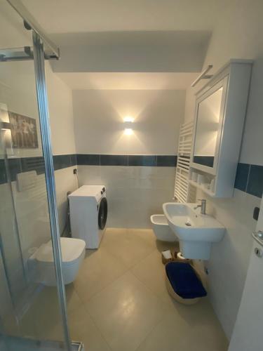 a bathroom with two toilets and a sink and a shower at Grande monolocale con parcheggio interrato incluso in Genoa